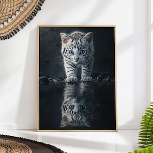 May include: A white kitten with blue eyes stands in a dark, reflective pool of water. The kitten's reflection is visible in the water, creating a symmetrical image.