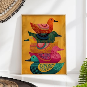 Może przedstawiać: Oprawiony wydruk przedstawiający pięć dekoracyjnych kaczek ułożonych w stos. Każda kaczka jest w żywych kolorach ze skomplikowanymi wzorami w odcieniach pomarańczu, zieleni, żółci i różu. Tło jest teksturowane na żółto.
