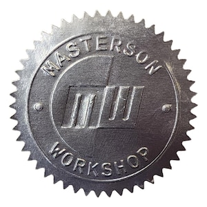 Silver sticker embossed with the Masterson Workshop logo