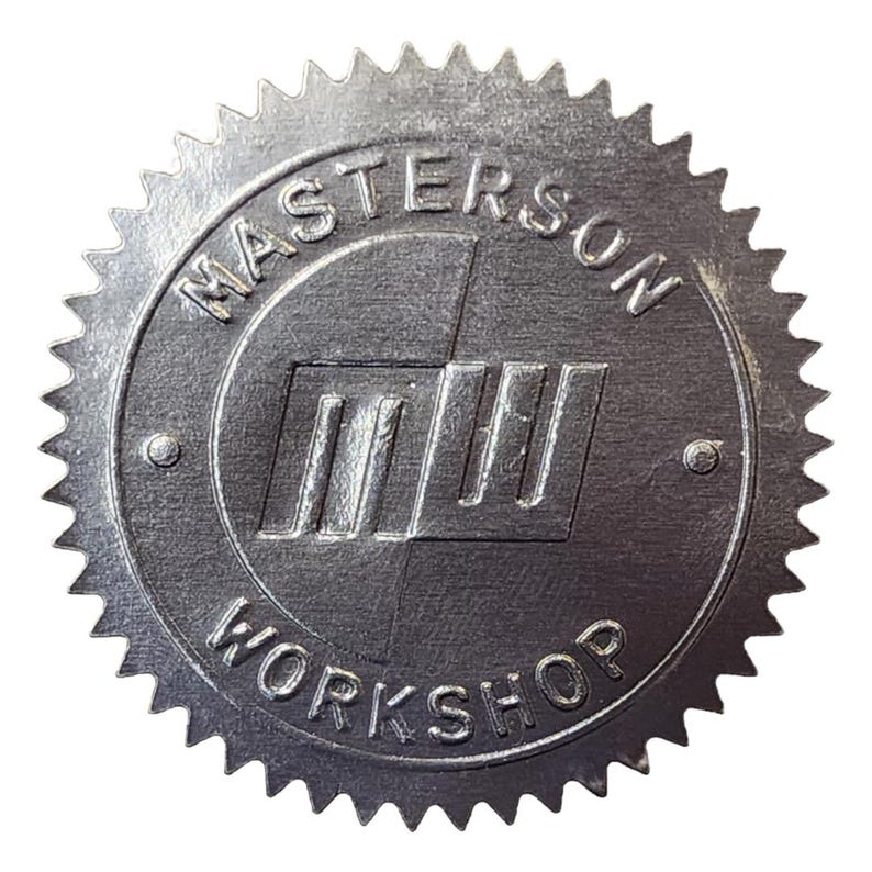 Silver sticker embossed with the Masterson Workshop logo