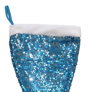 May include: A blue and silver sequin mermaid stocking with a white faux fur cuff.