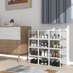May include: A white plastic shoe storage unit with clear drawers. The unit is stacked with multiple drawers and contains various pairs of shoes.