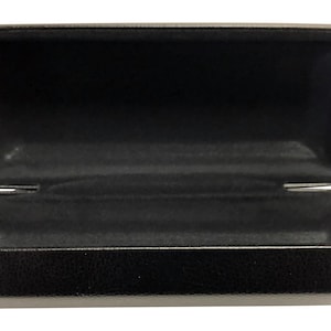 May include: A black rectangular eyeglasses case with a soft, black interior lining. The case is open and empty.
