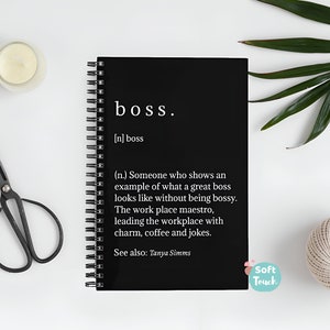 May include: Black spiral bound notebook with the word "boss" defined as "Someone who shows an example of what a great boss looks like without being bossy. The work place maestro, leading the workplace with charm, coffee and jokes." The notebook has the words "Soft Touch" printed on the bottom right corner.