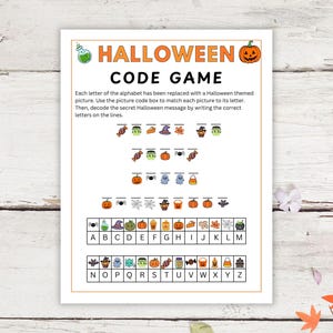 May include: A printable Halloween code game activity sheet featuring a title, instructions, and a cipher key. The page includes rows of blank lines with small Halloween-themed icons above them, and a grid matching icons to letters A through Z.