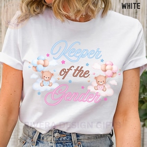 May include: White t-shirt with the text "Keeper of the Gender" in pink and blue lettering. Two teddy bears are holding balloons, one blue and one pink, above clouds with pink and blue stars.
