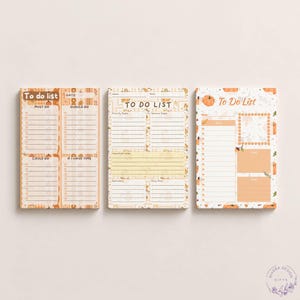 May include: Three rectangular to-do list notepads featuring autumn-themed designs with pumpkins and leaves. The pads include sections labeled To Do List, Must Do, Should Do, Could Do, If I Have Time, Priority Tasks, General Tasks, and Important Notes.