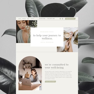 May include: A website design in neutral tones, displaying the text "NATURE NURTURE" and "to help your journey to wellness". The design incorporates images of a woman, a coffee cup, and a person using a laptop.