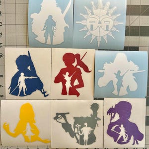 May include: A collection of vinyl decals featuring stylized silhouettes of figures with weapons and other designs. The decals are in various colors, including white, blue, red, yellow, gray, and purple. The decals are on a light blue backing.