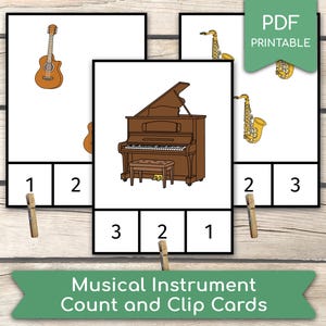 May include: Musical instrument count and clip cards featuring illustrations of a guitar, piano, and saxophone. Each card has a number and space for a clothespin. The cards are labeled "PDF Printable" and "Musical Instrument Count and Clip Cards."