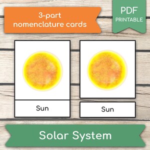 May include: Educational 3-part nomenclature cards featuring the sun. The cards have a bright yellow and orange sun illustration. The text "Sun" is below the image. The cards are labeled "3-part nomenclature cards" and "Solar System".