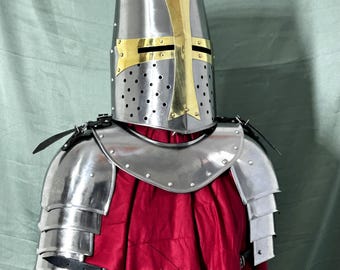 May include: A silver knight's helmet with a gold cross and a silver shoulder armor with a leather strap.