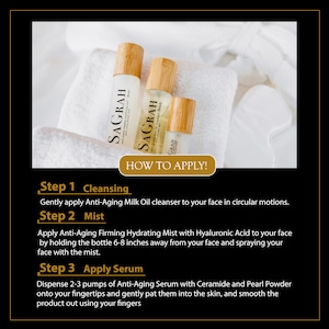 May include: Three brown glass bottles with bamboo caps and labels that say "SAGRAH" on a white towel. The bottles are labeled with the words "Anti-Aging Milk Oil Cleanser", "Anti-Aging Firming Hydrating Mist", and "Anti-Aging Serum". The text "HOW TO APPLY!" is in a gold box below the bottles. The text below the gold box describes the steps for using the products: "Step 1 Cleansing", "Step 2 Mist", and "Step 3 Apply Serum".