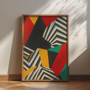 May include: A rectangular framed wall art piece featuring a geometric composition of bold red, yellow, and teal solid shapes contrasted with sections of black and white chevron stripes, all enclosed within a simple light-toned wooden frame.