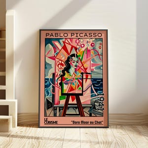 Może przedstawiać: Oprawiony wydruk z kolorowym kubistycznym portretem autorstwa Pablo Picasso, zatytułowany "Dora Maar au Chat" i datowany na 1941 rok. Dzieło przedstawia kobietę w żywym stylu, z różowymi, niebieskimi i czerwonymi odcieniami. Tekst "Le Cubisme" znajduje się na dole.
