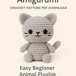 May include: A crocheted gray cat amigurumi plushie with black eyes and a brown nose. The image includes the text "Cute Mini Cat Amigurumi" and "Easy Beginner Animal Plushie". The plushie is a handmade craft project.