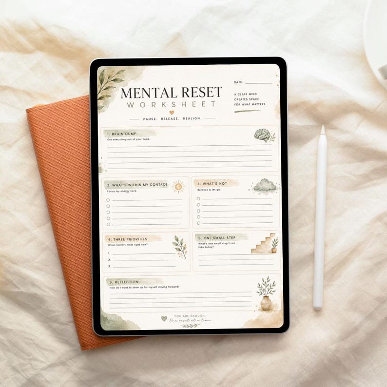 May include: A digital tablet displaying a Mental Reset Worksheet with sections for brain dump, control, priorities, and reflection. The page features soft watercolour botanical accents, a brain icon, a sun, a cloud, and text including "Pause, Release, Realign" and "You are enough."