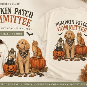 May include: An off-white t-shirt featuring the text PUMPKIN PATCH COMMITTEE and a graphic of a golden doodle dog wearing a plaid bandana, a tabby cat sitting on a pumpkin, a black cat in a jack-o'-lantern, a lantern, and small bats.