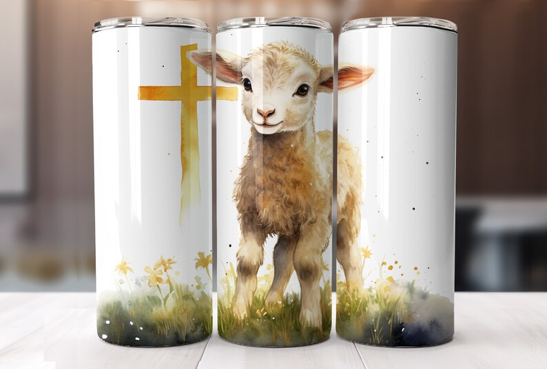 May include: A white stainless steel tumbler with a watercolor design of a lamb standing in a field of grass with a gold cross behind it.