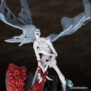 May include: A white, skeletal figure with large, translucent wings. The figure has a gaunt face and is holding a red, textured object. The figure is standing on a dark, rocky base. The overall theme is fantasy or horror.