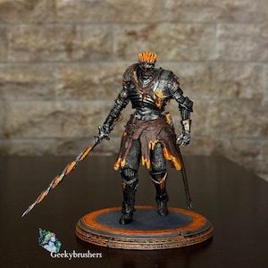 May include: A detailed figurine of a knight in black armour with orange and gold accents. The knight is holding a sword with a twisted orange and black blade. The figurine is standing on a circular base with an orange border. The text "Geekybrushers" is visible.