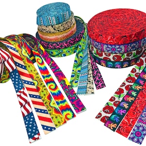 May include: Assortment of colorful patterned webbing rolls, including red, white, and blue, tie-dye, and floral designs. The rolls are arranged in a pile and fanned out.