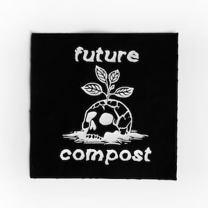 Pu&ograve; includere: Toppa nera con testo e grafica bianchi. Il testo recita "future compost". La grafica &egrave; un teschio con una pianta che cresce dalla cima.