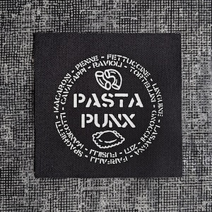 May include: Black and white logo on a black fabric patch with the text "PASTA PUNX" and a list of pasta types surrounding the text.