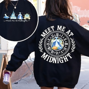 May include: Black sweatshirt with a circular graphic on the back featuring a clock, a dress, and the words "Meet Me at Midnight." The front has a smaller graphic with a shoe, castle, dress, and carriage. The text "meet me at midnight" is also present.
