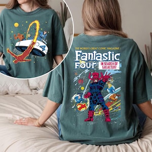 May include: Teal-colored t-shirt featuring a comic book design. The front graphic shows the Fantastic Four in a vehicle with the number 4. The back of the shirt displays the Fantastic Four comic book cover with Galactus. The text reads "Fantastic Four in Search of Galactus!"