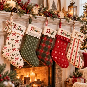 May include: Five personalized Christmas stockings hanging in a row. From left to right: a cream stocking with holly and bows labeled Riley, a green striped one labeled Mom, a plaid one labeled Dad, a red one with deer labeled Amelia, and a red striped one labeled Luna.