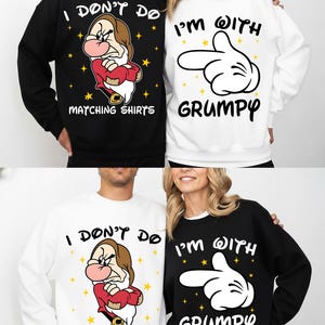 May include: Matching black and white sweatshirts. The black sweatshirt has an image of Grumpy from Snow White with the text "I DON'T DO MATCHING SHIRTS". The white sweatshirt features a Mickey Mouse hand with the text "I'M WITH GRUMPY".