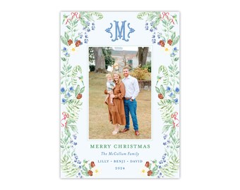 May include: A Christmas card with a family photograph, framed by a floral border. The card includes the text "MERRY CHRISTMAS" and the family name. The floral border features green leaves, red bows, and blue flowers. The year 2024 is printed at the bottom.