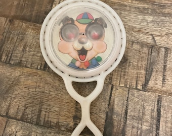 Vintage plastic baby rattle with anamorphic animals on each side