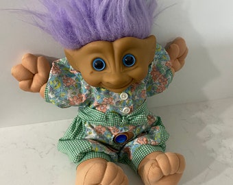 Ace Novelty Troll 1991 with purple gem and hair flowers and green gingham material jumpsuit approximately 12 inches