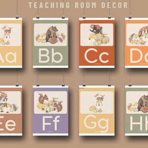 May include: Eight colorful alphabet posters featuring a different animal and letter for each poster. The posters are decorated with fall-themed elements like pumpkins, leaves, and acorns. The letters are in a large, bold font and are easy to read.