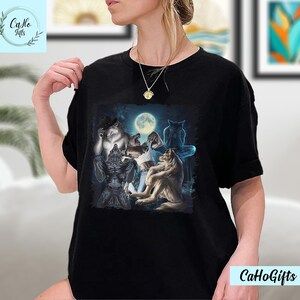 May include: Black t-shirt with a graphic print of five wolves howling at the moon. The wolves are in a dark forest setting.