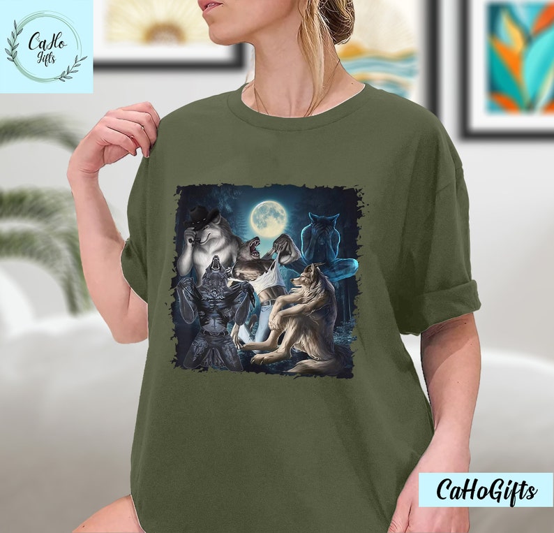 May include: A green t-shirt with a graphic print of a group of wolves howling at the moon. The wolves are in a dark forest setting.