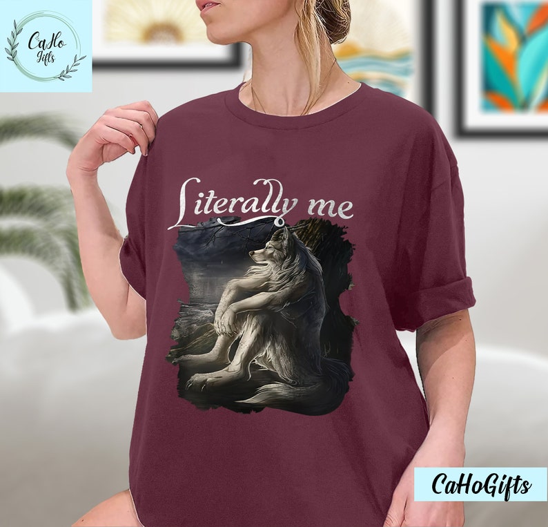 May include: A maroon t-shirt with a white wolf illustration and the text "literally me" printed on the front.