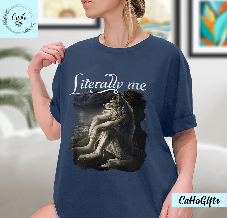 May include: A navy blue t-shirt with a white wolf illustration and the text "literally me" printed on the front.