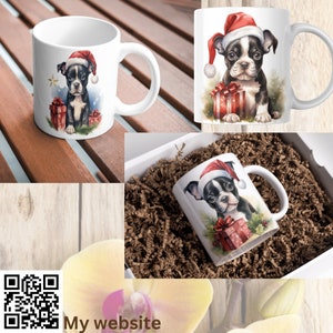 May include: White ceramic mug with a Christmas-themed design featuring a Boston Terrier puppy wearing a Santa hat and holding a gift box. The puppy is surrounded by green foliage and a red star.
