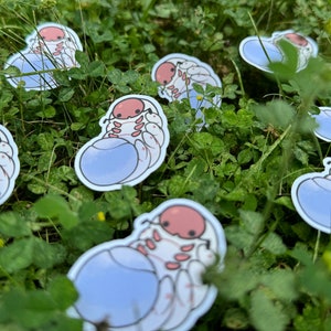 May include: A set of seven stickers featuring a cartoon pill bug with a light blue shell and pink body. The stickers are on a green grassy background.