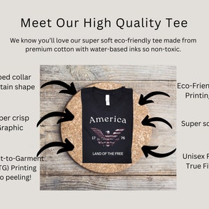 May include: Black t-shirt with a graphic of an American eagle and the words "America" and "Land of the Free". The shirt is made from premium cotton and features a ribbed collar, super crisp graphic, and eco-friendly printing.
