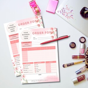 May include: Two pink order forms with floral designs. The forms have sections for customer information, delivery, payment, and amount. The text on the form says "Order Form".