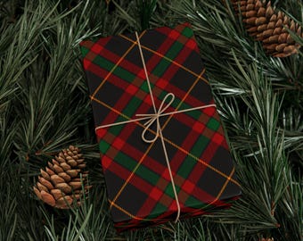 May include: A wrapped gift with a black, red, green, and yellow plaid pattern, tied with twine. The gift is surrounded by green pine needles and pine cones, creating a festive holiday scene.