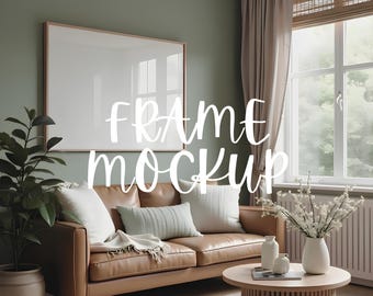May include: A brown leather sofa with white and light blue cushions, a white throw blanket, and a framed picture on the wall behind it. There is a coffee table in front of the sofa with a book and two decorative vases on it. The room is decorated in a modern style with a green wall and a window with white curtains.