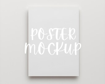 May include: A rectangular, off-white poster mockup with the words "POSTER MOCKUP" in white script. The poster is centered on a light gray background, creating a clean and minimalist aesthetic. Ideal for showcasing artwork or designs.