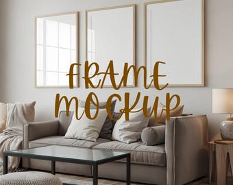 May include: A living room scene featuring a gray sofa, a black coffee table, and a patterned rug. Three framed art mockups hang on the wall above the sofa. The text "FRAME MOCKUP" is displayed in a brown script font.