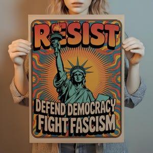 May include: A poster with the Statue of Liberty illustration, holding a torch, with the words "RESIST", "DEFEND DEMOCRACY", and "FIGHT FASCISM" in bold, retro-style lettering. The background features a sunburst design with orange, blue, and yellow hues.
