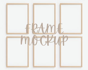 May include: Six rectangular wooden picture frames with white interiors are arranged on a white background. The words "FRAME MOCKUP" are superimposed over the frames in a light brown color. The frames are empty, ready for artwork or photos.